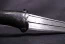 Dagger with black stone handle and damascus blade. Handicraft production.