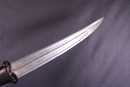 Dagger with black stone handle and damascus blade. Handicraft production.