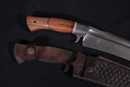 Bowie knife with damascus blade and leather scabbard. Handicraft production. 