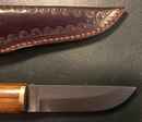 Viking knife with damascus or wootz blade, wood handle and leather scabbard.