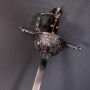 Rapier decorated with musketeers, unsuitable for fencing.