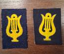Yellow cutout lyre shapes, outlined in gold, set against a bluish iron-grey or black background. Very limited stock.