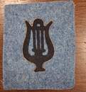 Blue cutout lyre shapes, outlined in gold, set against a horizon blue background. Very limited stock.
