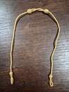 Gold-colored sliding chin straps for caps. New old stock. Price per unit 