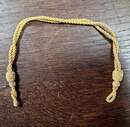 Gold-colored sliding chin straps for caps. New old stock. Price per unit 
