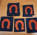 WWI. Badge with a red/very dark navy blue horseshoe. Second-quality item.