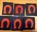 WWI. Badge with a red/very dark navy blue horseshoe. Second-quality item.