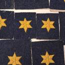 A small, affordable piece of (Belgian) history. A cross with six yellow arms on a blue-grey iron background. Price per unit