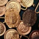 Lot of 47 belt plates featuring an anchor or the head of Medusa.