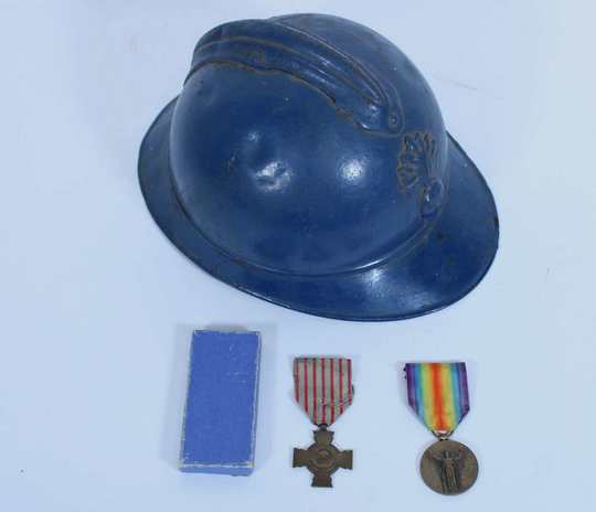 Adrian infantry helmet, WWI, inside partly lacking, with 2 medals