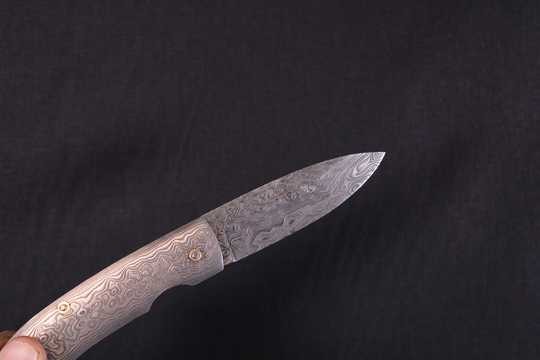 Folding knife all in damascus made. Handicraft production. 