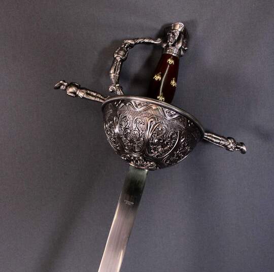 Rapier decorated with musketeers, unsuitable for fencing.
