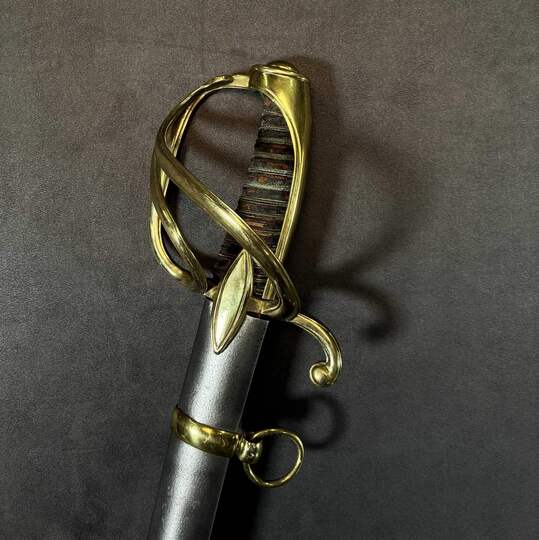Light cavalry officer's saber, Empire/restoration. Blade engraved with blue and gold decoration. Scabbard with brass fittings.