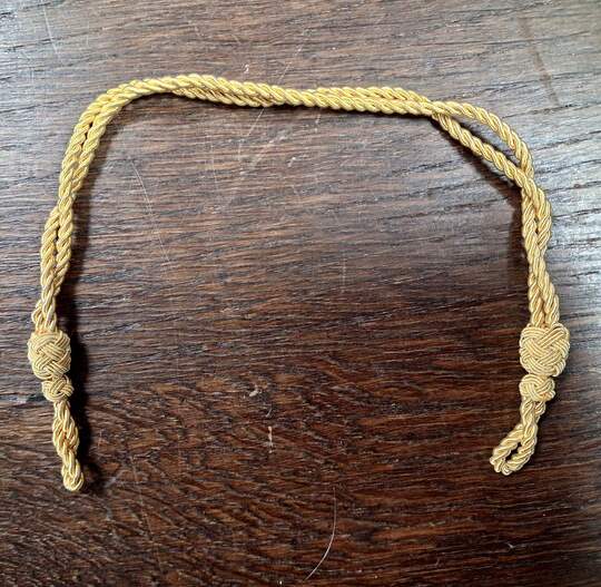 Gold-colored sliding chin straps for caps. New old stock. Price per unit 