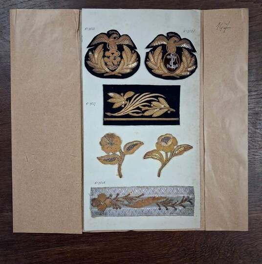 Display board of military specialty embroidery samples from the David firm, intended for the Mexican army, circa 1900.