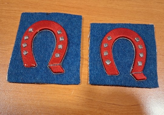 WWI. Embroidered red iron-style badge with gold/bluish-iron-grey studs. 