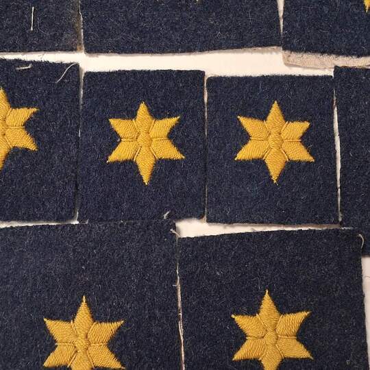 A small, affordable piece of (Belgian) history. A cross with six yellow arms on a blue-grey iron background. Price per unit